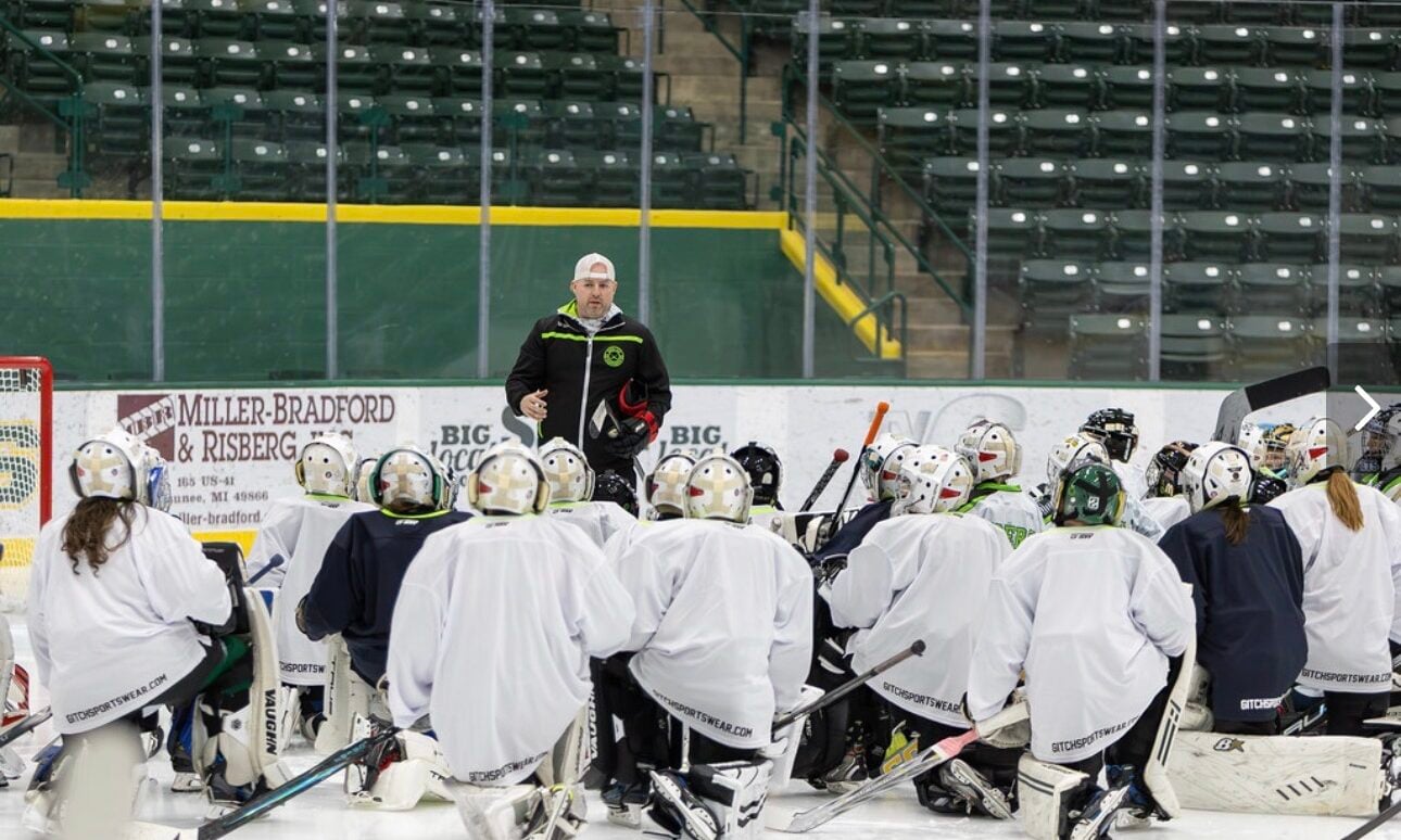 Goalies, Inc. coach Jim Stanaway teaching youth hockey goalies on the ice at a goalie camp